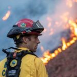 Firefighters battle to corral Los Angeles fires before strong winds return