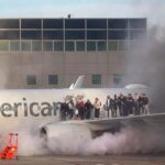 Passengers evacuate after American Airlines plane catches fire in Denver