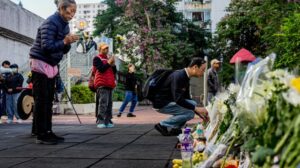Hong Kong mourns victims of blaze as search for remains continues